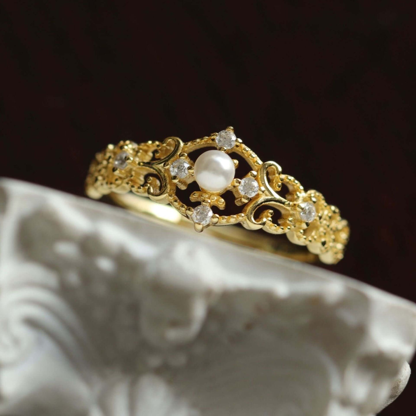 Elegant gold ring with pearl and crystals, featuring intricate floral detailing, perfect for women.